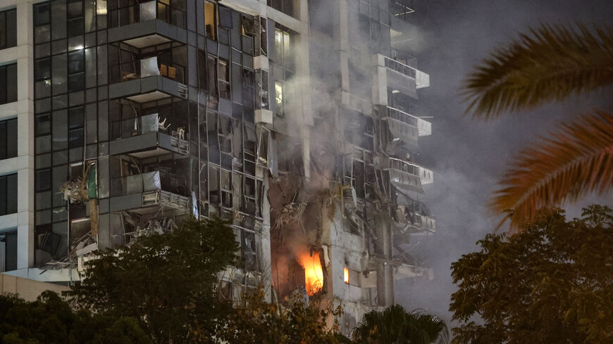 Fire and smoke rise from a building, reportedly hit by a missile fired from Iran, in central Tel Aviv on June 13, 2025.