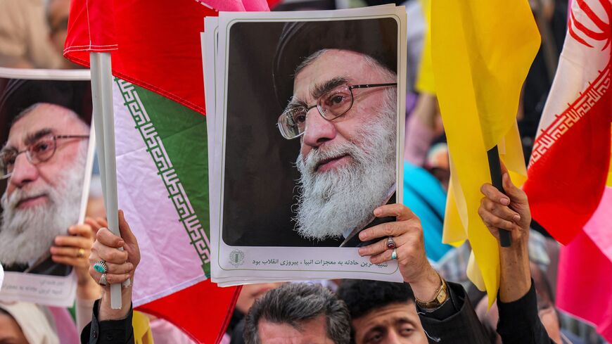 A picture of Iran's supreme leader, Ayatollah Ali Khamenei, is held aloft at a rally on Enghelab (Revolution) Square, Tehran, June 14, 2025.
