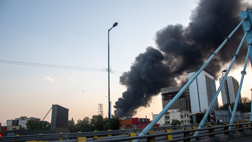 Smoke rises from the rubble of an Iranian state media building in Tehran after an Israeli airstrike on June 16, 2025.