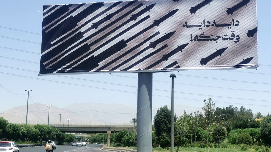 Commuters drive past an anti-Israel billboard in Tehran, on June 22, 2025. President Donald Trump said the US military carried out strikes on June 22 on three Iranian nuclear sites and that Tehran "must now agree to end this war", following days of speculation over whether the United States would join its ally Israel's bombing campaign. (Photo by ATTA KENARE / AFP) (Photo by ATTA KENARE/AFP via Getty Images)