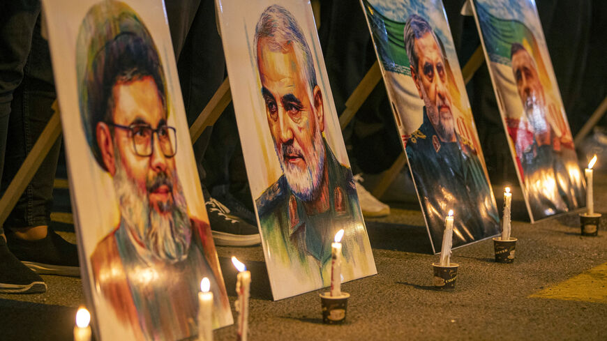 Pictures of Lebanese Hezbollah's slain leader Hashem Safieddine (L) and Iran's Islamic Revolutionary Guard Corps (IRGC) commander Qassem Soleimani (2nd-L) and others during a memorial vigil mourning slain members of the IRGC and scientists killed in recent Israeli airstrikes, outside the Iranian embassy headquarters in Baghdad on June 28, 2025. Iran held a state funeral service on June 28 for around 60 people, including its military commanders, killed in its war with Israel, after Tehran's top diplomat cond
