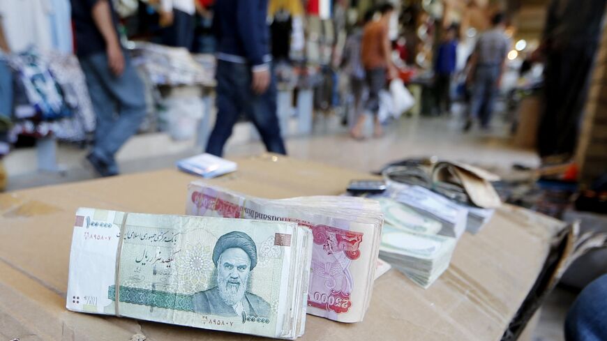 Iranian rial banknotes bearing a portrait of the late founder of the Islamic Republic of Iran, Ayatollah Ruhollah Khomeini, sit on the stand of an Iraqi money dealer on June 19, 2014, in Arbil, Iraq.