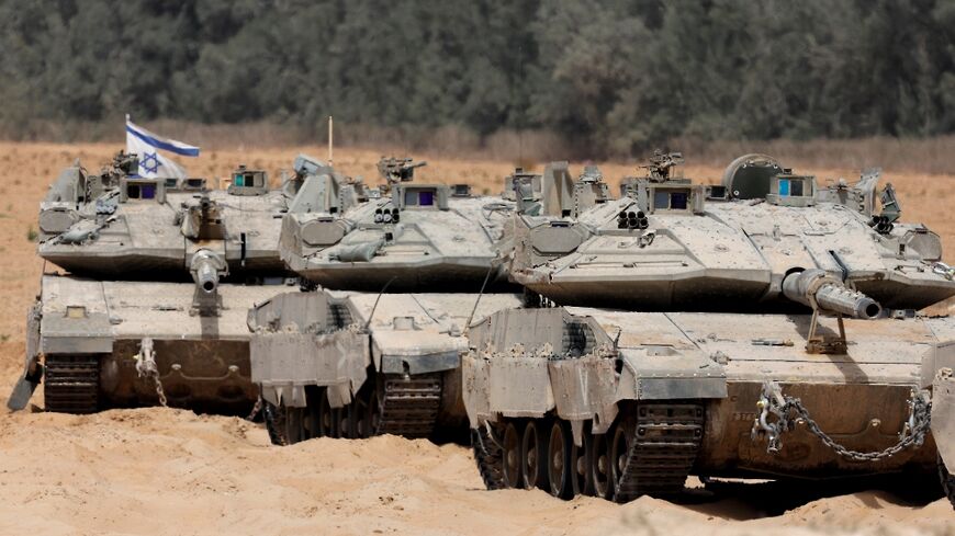 Israeli troops deploy at the border with the Gaza Strip on Tuesday, as the military announced it had expanded its campaign in the territory