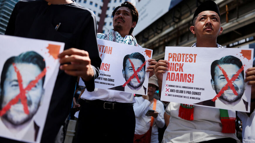 Protesters hold pictures of Nick Adams as they protest U.S. President Donald Trump's nomination of Nick as the U.S. ambassador to Malaysia, outside the U.S. Embassy in Kuala Lumpur, Malaysia July 18, 2025. REUTERS/Hasnoor Hussain