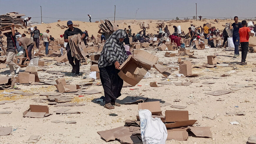FILE PHOTO: Palestinians gather to collect what remains of relief supplies from the distribution center of the U.S.-backed Gaza Humanitarian Foundation, in Rafah, in the southern Gaza Strip, June 5, 2025. REUTERS/Stringer/File Photo