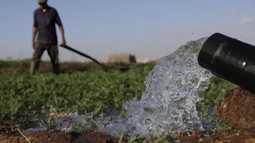 Farmers irrigate their field in the Chtouka region of southern Morocco
