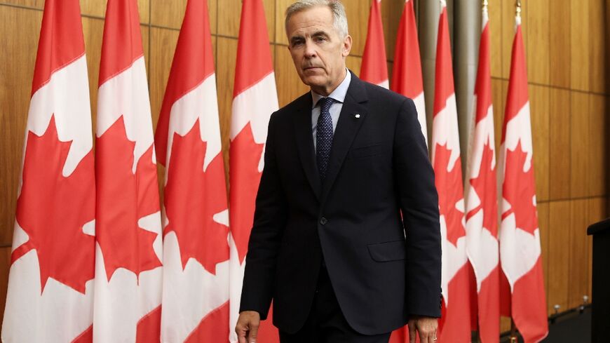 Canadian Prime Minister Mark Carney exits a press conference after announcing plans to recognize a Palestinian state