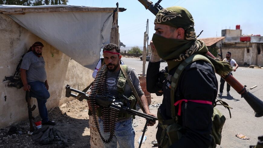 Armed Bedouin gather in the village of Al-Mazraa outside Sweida as clashes flare with Druze fighters, a day after the Syrian army withdrew from the province, heartland of the Druze minority.