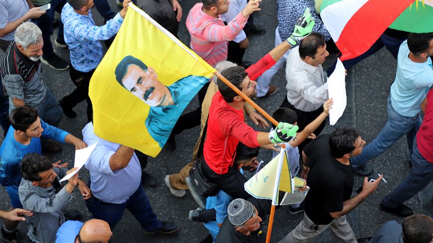 An Iraqi Kurdish man holds a flag with the portrait of jailed Kurdish militant leader Abdullah Ocalan during a demonstration in the northern Iraqi Kurdish city of Sulaimaniyah on Oct. 10, 2019 against the Turkish offensive in northeastern Syria.