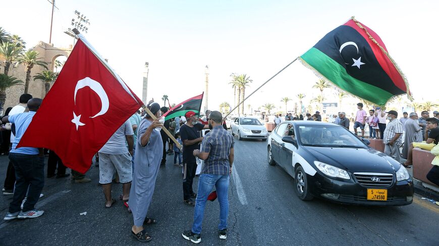 People wave flags of Libya (R) and Turkey (L) during a demonstration in the Martyrs' Square in the center of the Libyan capital Tripoli on June 21, 2020.
