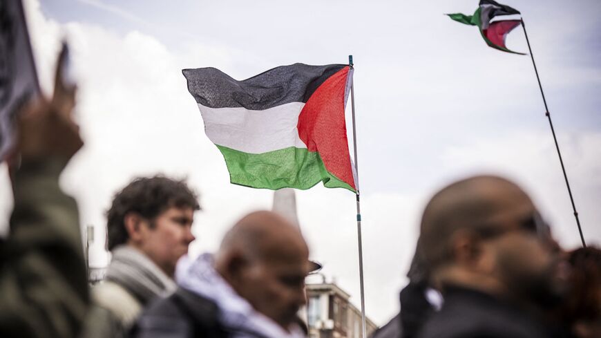 Protesters hold Palestinian flags during a demonstration organized by several peace organizations in support of Palestinians amid the Israel-Hamas war in the Gaza Strip, at Dam Square in Amsterdam, on Oct. 13, 2024.