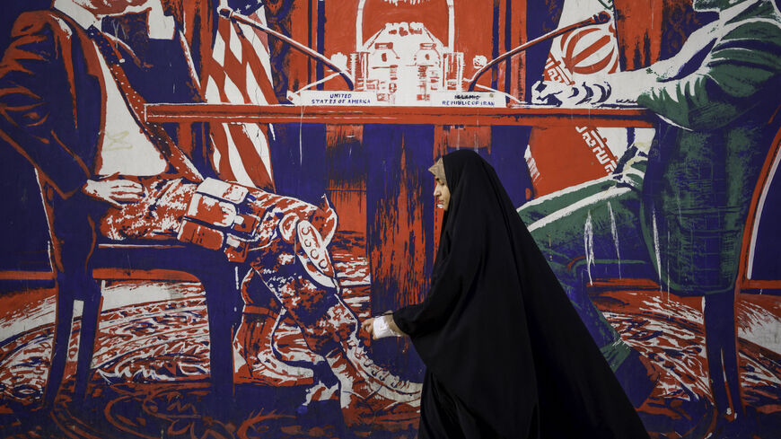 Iranians pass by the anti-American murals painted on the walls of the former embassy of the United States of America in Tehran, Iran on April 16, 2025, four days after Iran held the first round of indirect nuclear negotiations with President Trump's administration hosted and mediated by Oman. (Photo by Mohammadali Najib / Middle East Images / Middle East Images via AFP) (Photo by MOHAMMADALI NAJIB/Middle East Images/AFP via Getty Images)