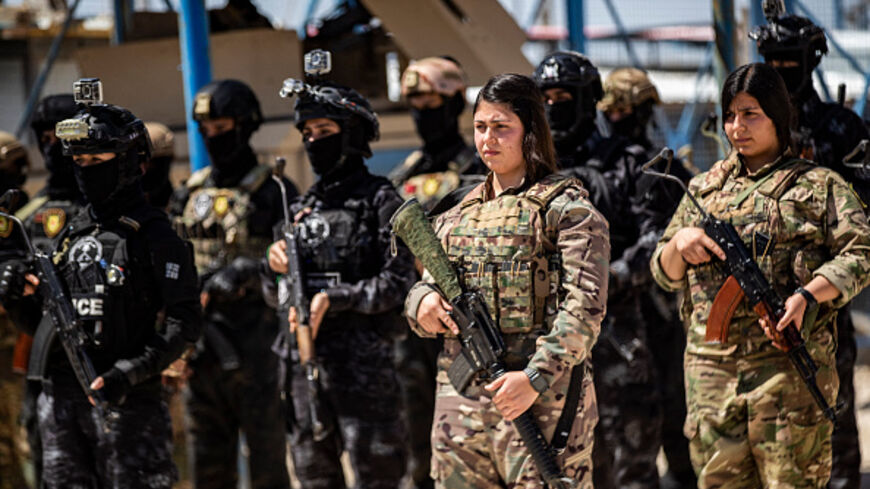 Members of the Syrian Kurdish Asayish security forces stand guard at the Kurdish-run al-Hol camp in the northeastern Hasakeh governorate, on April 18, 2025. (DELIL SOULEIMAN/AFP via Getty Images)