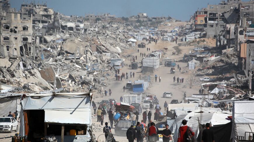 Palestinians carry their belongings as they flee Gaza City, May 16, 2025. 