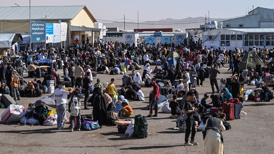 Afghan refugees are pictured at the Islam Qala border crossing between Afghanistan and Iran on June 28, 2025, following their deportation from Iran.
