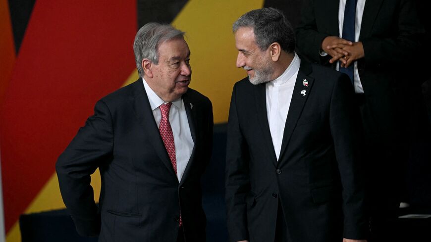 United Nations Secretary-General Antonio Guterres (L) and Iran's Foreign Minister Abbas Araghchi talk.