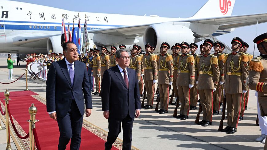 Egypt's Prime Minister Mustafa Madbouly (L) welcomes China's Premier Li Qiang upon his arrival at Cairo International Airport in Egypt's capital, on July 9, 2025.