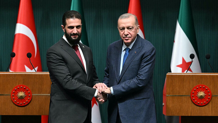 Turkish President Recep Tayyip Erdogan (R) and Syria's interim President Ahmed al-Sharaa shake hands during a joint press conference following their meeting at the Presidential Palace in Ankara, on Feb. 4, 2025. — OZAN KOSE/Getty
