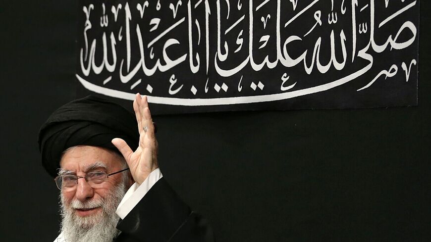 Iran's supreme leader Ayatollah Ali Khamenei waves to the audience in this handout picture released by his office
