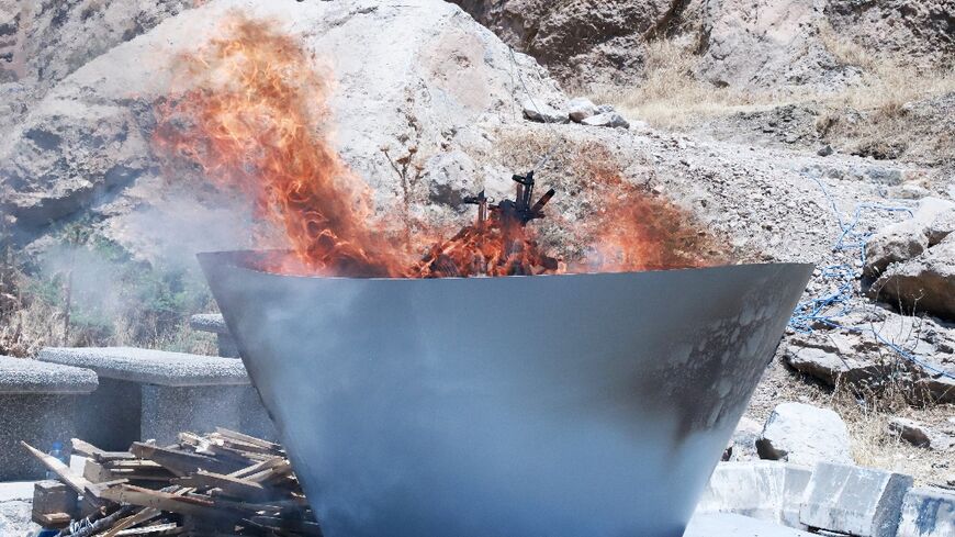 A first group of PKK militants burnt their weapons at a symbolic ceremony in northern Iraq 