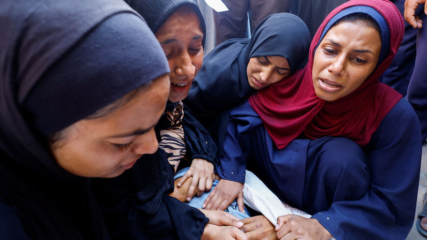 People mourn during the funeral of Palestinians, who were killed by Israeli fire while trying to receive aid on Sunday, according to medics, at Al-Shifa Hospital, in Gaza City, August 4, 2025. REUTERS/Mahmoud Issa