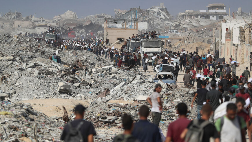 FILE PHOTO: Palestinians carry aid supplies that entered Gaza through Israel, in Beit Lahia, northern Gaza Strip, August 2, 2025. REUTERS/Mahmoud Issa/File Photo