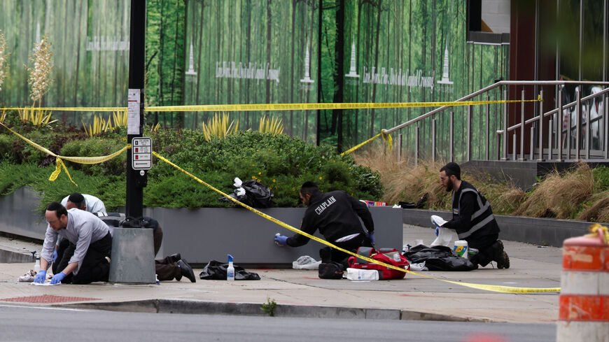 FILE PHOTO: Members of the group Misaskim clean blood off the ground where two Israeli embassy staff were shot dead near the Capital Jewish Museum in Washington, D.C., U.S. May 22, 2025.  REUTERS/Evelyn Hockstein/File Photo