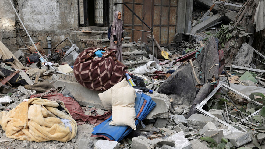 FILE PHOTO: A Palestinian woman inspects the site of an overnight Israeli strike on a house, in Gaza City August 7, 2025. REUTERS/Dawoud Abu Alkas/File Photo