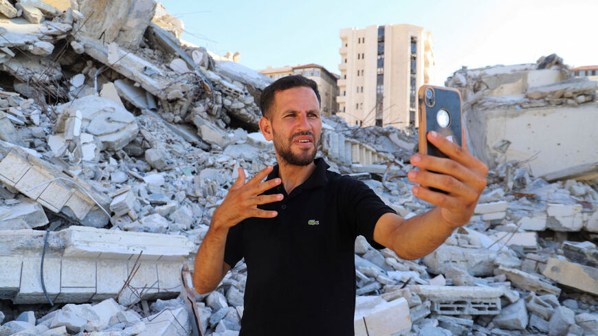 Hearing-impaired Palestinian influencer Basem Al-Habel, who turned to social media to document the war in Gaza through sign language, reaching a wide range of followers from both inside and outside of the enclave, films himself in Gaza City, August 5, 2025.REUTERS/Ebrahim Hajjaj