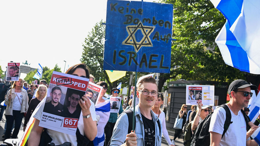 FILE PHOTO: A demonstrator holds a sign reading "No bombs on Israel" during a protest demanding the release of hostages kidnapped during the deadly October 7, 2023, attack on Israel by Hamas, in Berlin, Germany, August 7, 2025. REUTERS/Annegret Hilse/File Photo
