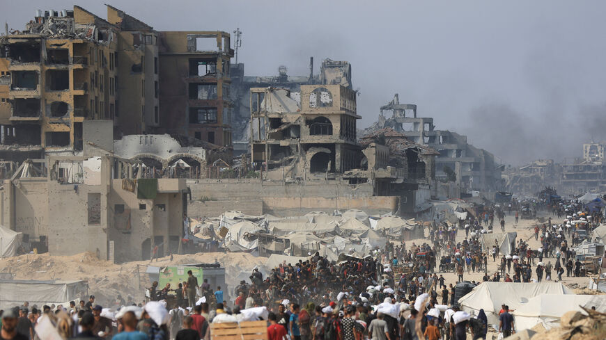FILE PHOTO: Palestinians carry aid supplies they collected from trucks that entered Gaza through Israel, in Beit Lahia, in the northern Gaza Strip August 10, 2025. REUTERS/Dawoud Abu Alkas/File Photo