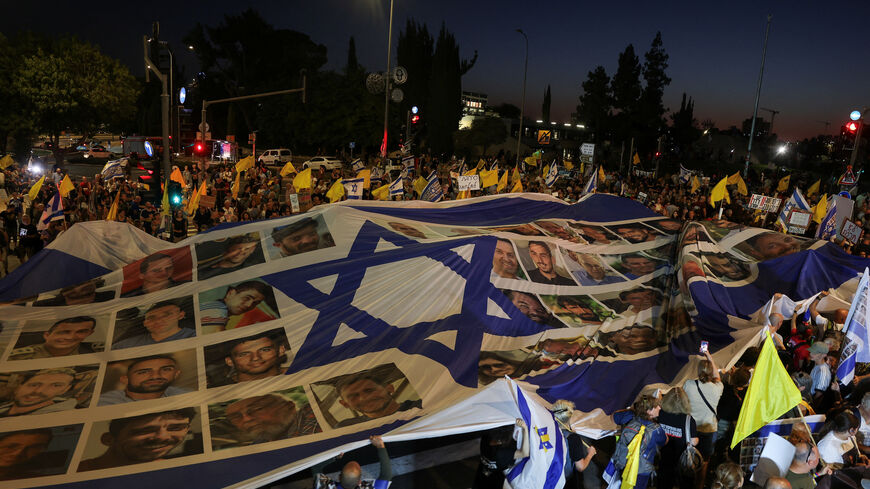Demonstrators hold a banner, during a protest outside Israeli Prime Minister Benjamin Netanyahu's office, to demand the immediate release of the hostages kidnapped during the deadly October 7, 2023, attack on Israel by Hamas, and the end of the war, in Jerusalem, August 7, 2025. REUTERS/Ronen Zvulun/File Photo
