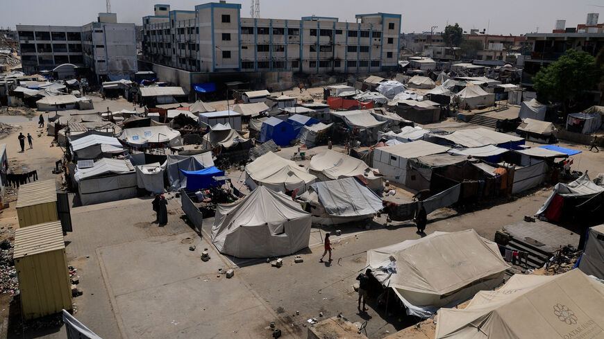 Palestinians displaced by the Israeli military offensive shelter in an UNRWA school, in Khan Younis, in the southern Gaza Strip, August 19, 2025. REUTERS/Hatem Khaled