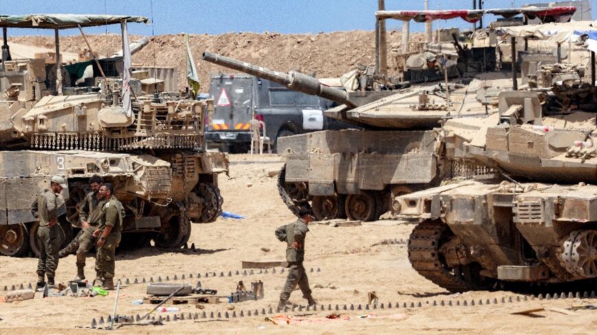 Israeli army soldiers perform maintenance tasks near the border with the Gaza Strip