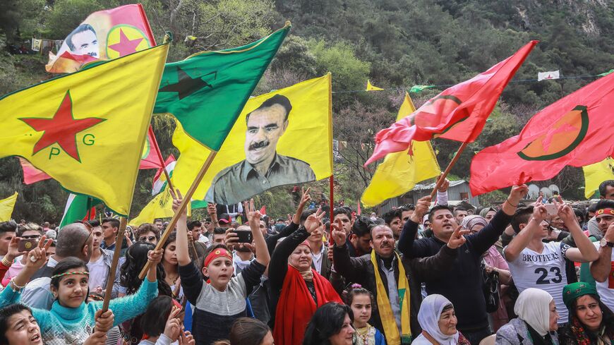 Members of the Lebanese Kurdish community wave the flags of (L to R) the Kurdish People's Protection Units (YPG), Women's Protection Units (YPJ), another showing jailed Kurdish militant leader Abdullah Ocalan, and the flag of the Kurdistan Workers' Party (PKK), during a celebration marking the spring festival of Nowruz (Noruz) in Lebanon's coastal town of Damour, 24 kilometers south of Beirut, on March 24, 2019. 