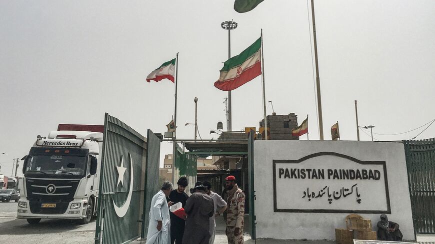 Pakistani security personnel check the documents of people who came from Iran at the Pakistan-Iran border in Taftan on June 16, 2025.