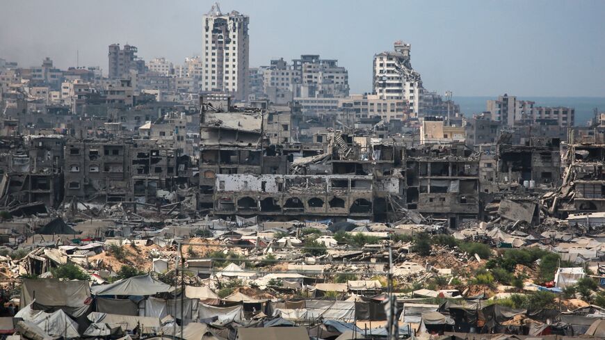 Buildings destroyed in Israeli strikes surround makeshift shelters for displaced Palestinians in Gaza City, on Aug. 8, 2025. 