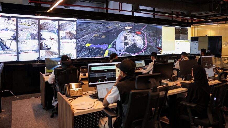Employees work in the control room for traffic and crowd management for pilgrims at the General Transport Center at the Royal Commission for Mecca and Holy Sites in Mecca on June 3, 2025.