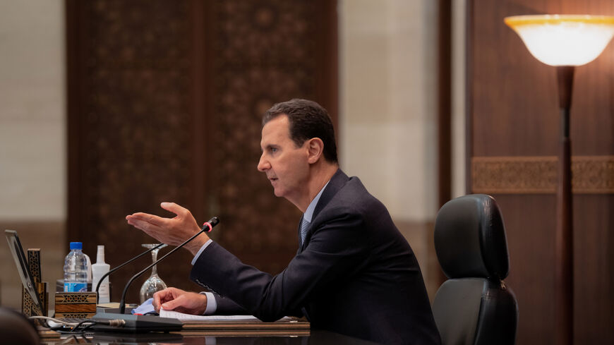 FILE PHOTO: Syria's President Bashar al-Assad speaks as he meets with the Syrian cabinet in Damascus, Syria in this handout picture released by Sana on March 30, 2021. SANA/Handout via REUTERS/ File Photo