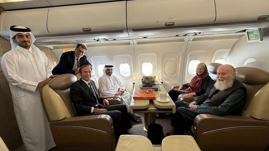 British citizens named Peter and Barbara Reynolds, who had been in custody in Afghanistan, sit with Qatari and British diplomats, on an aircraft, in the air, September 19, 2025. Qatar Government/Handout via REUTERS
