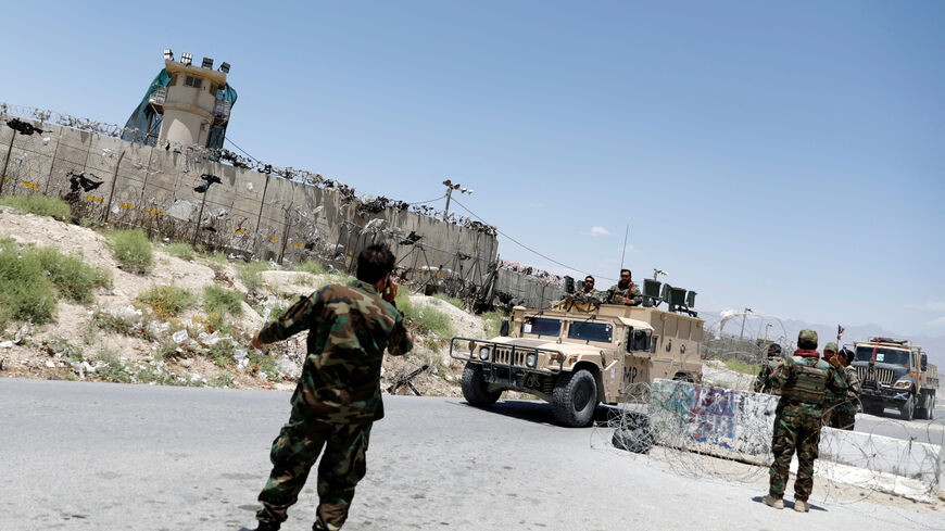 FILE PHOTO: Afghan soldiers stand guard at a checkpoint outside the U.S Bagram air base, on the day the last of American troops vacated it, Parwan province, Afghanistan July 2, 2021.REUTERS/Mohammad Ismail/File Photo