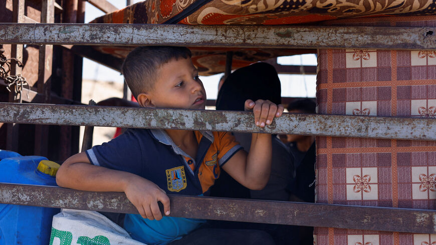 A child, part of crowds of displaced Palestinians fleeing northern Gaza due to an Israeli military operation, rides southward in a vehicle packed with personal belongings, after Israeli forces ordered residents of Gaza City to evacuate to the south, in the central Gaza Strip, September 21, 2025. REUTERS/Mahmoud Issa