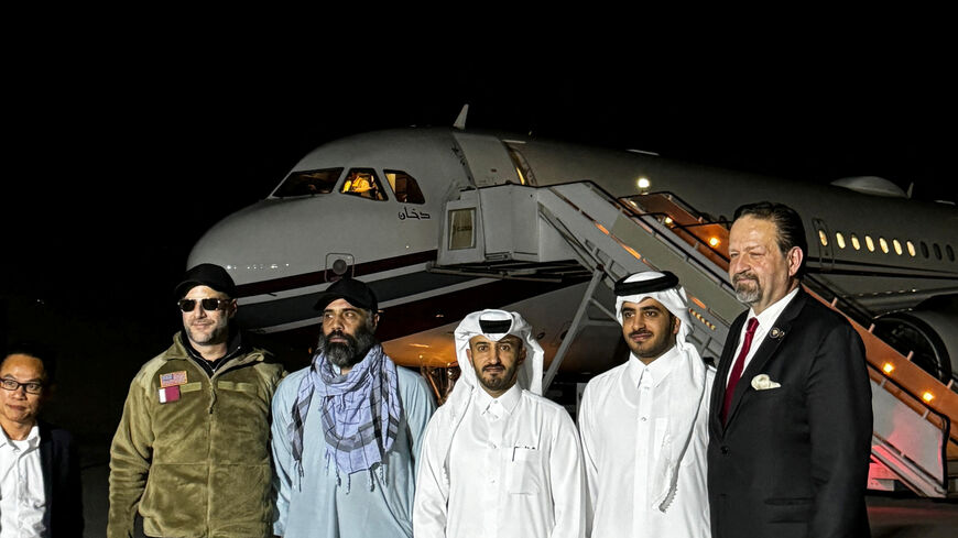 Amir Amiri, who had been detained in Afghanistan since December 2024, poses for a picture alongside Adam Boehler, the U.S. special envoy for hostage response, Sebastian Gorka, the deputy assistant to the U.S. president and senior director for counterterrorism, Qatari diplomats and others before boarding a plane in Kabul Afghanistan, September 28, 2025 in this handout image. Qatari Diplomat/Handout via REUTERS