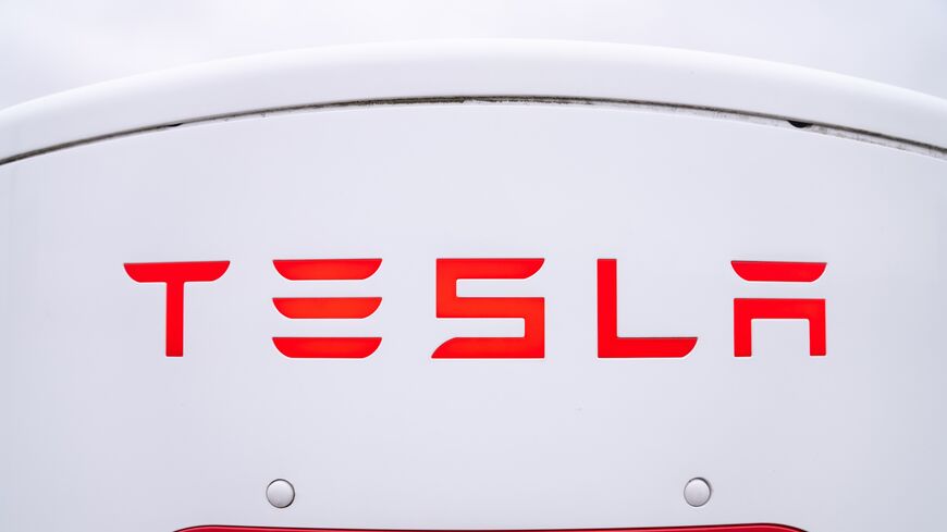 The logo of a Tesla electric vehicle charging station in a parking lot on March 20, 2025, in Hamilton, Canada.