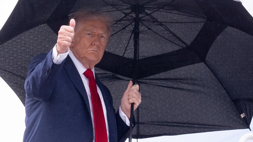 US President Donald Trump gives a thumbs up while boarding Air Force One bound for Israel, where he will address parliament and meet with hostage families, and then Egypt for a major peace summit