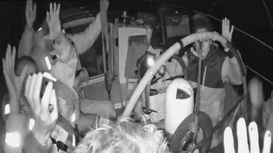 A screengrab from a live stream video shows crew of a Gaza-bound vessel, part of the Global Sumud Flotilla, raise their hands as they are surrounded by Israel Defense Forces, October 2, 2025. Global Sumud Flotilla/Handout via REUTERS