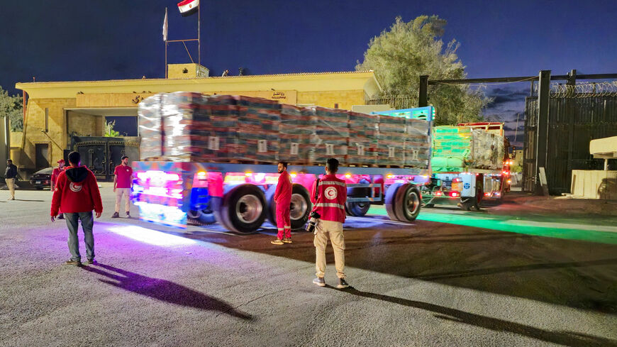 FILE PHOTO: Trucks carrying aid bound for Gaza cross the border crossing between Egypt and the Gaza Strip, after a ceasefire between Israel and Hamas in Gaza went into effect, in Rafah, Egypt, October 12, 2025. REUTERS/Stringer/File Photo