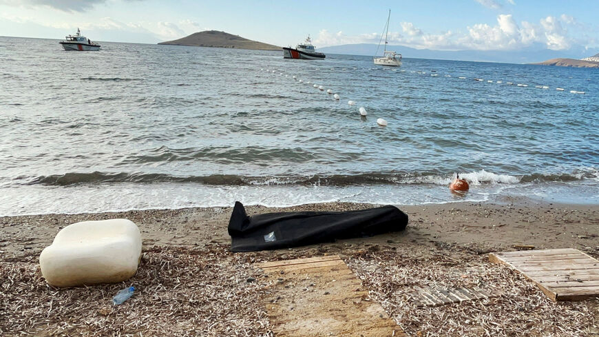 A body bag lies on the shore as Coast Guard Command members conduct a search and rescue operation following the sinking of a migrant boat off Bodrum, western Mugla province, Turkey, October 24, 2025. REUTERS/Kenan Gurbuz