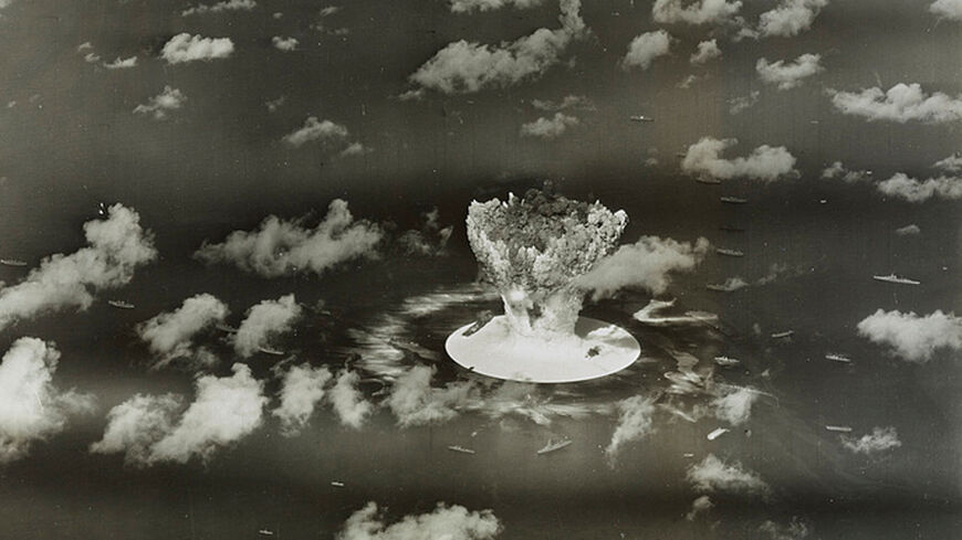 FILE PHOTO: A mushroom cloud rises with ships below during Operation Crossroads nuclear weapons test on Bikini Atoll, Marshall Islands in this 1946 handout provided by the U.S. Library of Congress.  The United States said on April 25, 2014, it was examining lawsuits filed by the Marshall Islands against it and eight other nuclear-armed countries that accuse them of failing in their obligation to negotiate nuclear disarmament.  REUTERS/U.S. Library of Congress/Handout via Reuters/File Photo