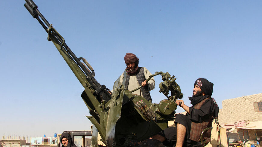 An Afghan Taliban fighter sit next to an anti-aircraft gun near the Afghanistan-Pakistan border in Spin Boldak, Kandahar Province, following exchanges of fire between Pakistani and Afghan forces in Afghanistan, October 15, 2025. REUTERS/Stringer
